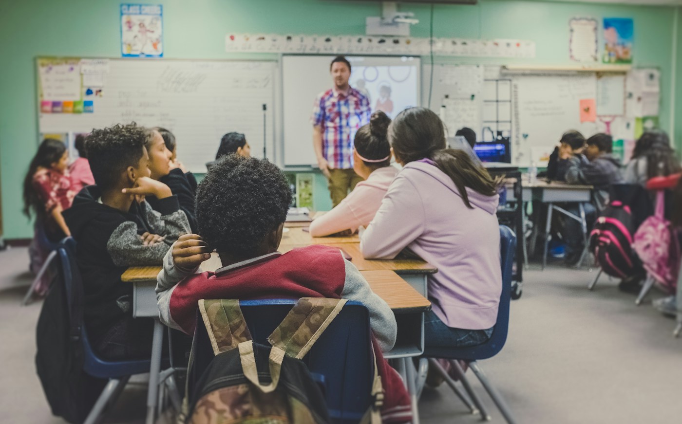 Teacher helping children with a classroom learning activity